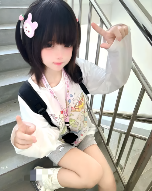 Person wearing a Harajuku Desserts T-Shirt with a kawaii design, posing on stairs.