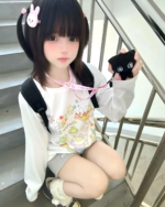 Person wearing a Harajuku Desserts T-Shirt with a cute bunny accessory.