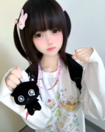 Person wearing a Harajuku Desserts T-Shirt featuring cute character prints.