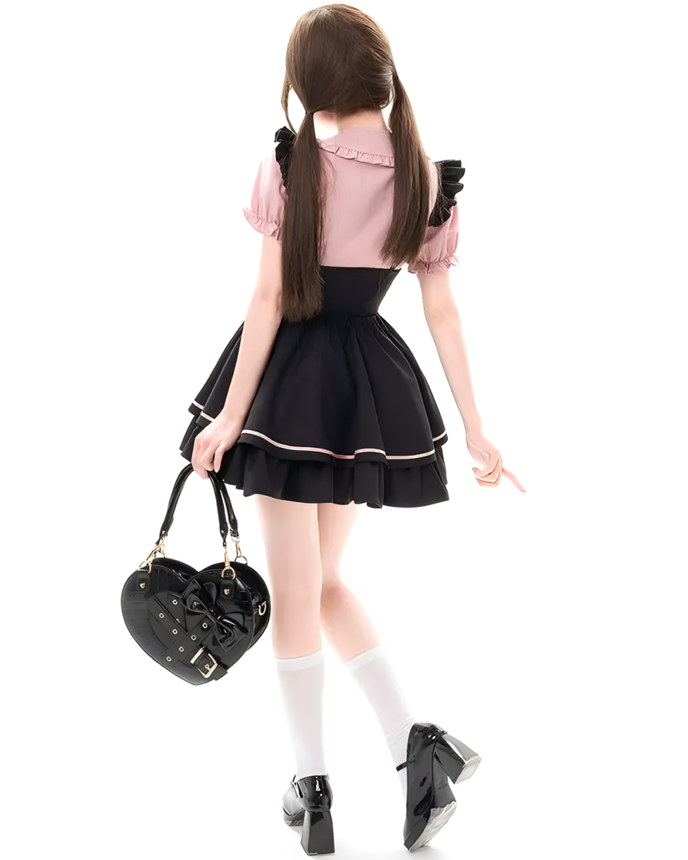 Model wearing a Heartache Lace-Up Pinafore Coord, a Jirai Kei outfit with pink sleeves and a black skirt. Includes a heart-shaped bag.