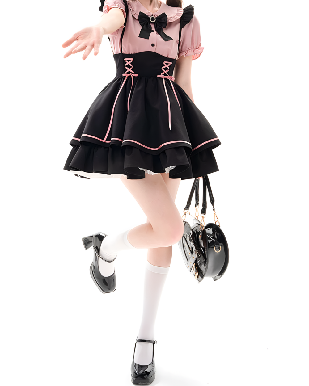 Model wearing a black and pink Jirai Kei outfit with lace-up detail and a matching handbag. Features a pinafore coord aesthetic.