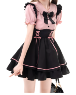 Model wearing a pink and black Heartache Lace-Up Pinafore Coord, a Jirai Kei outfit with ruffled sleeves and a layered skirt.