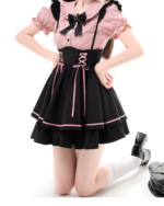 Model wearing a Heartache Lace-Up Pinafore Coord, a Jirai Kei outfit with a black and pink color scheme. Includes a dress and straps.