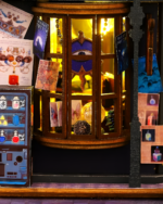 Close-up of a lit Holo Magic City Building Set window display with potion bottles and magical items.