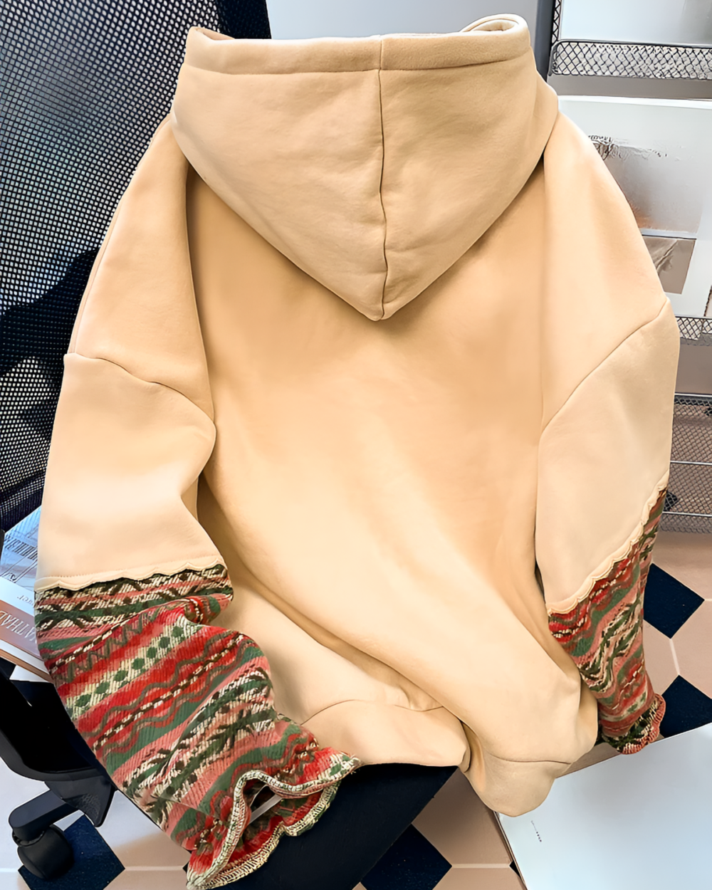 Close-up of a mountain graphic hoodie featuring an ethno-chic design and detailed embroidery.