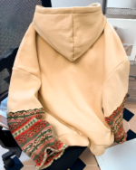 Close-up of a mountain graphic hoodie featuring an ethno-chic design and detailed embroidery.