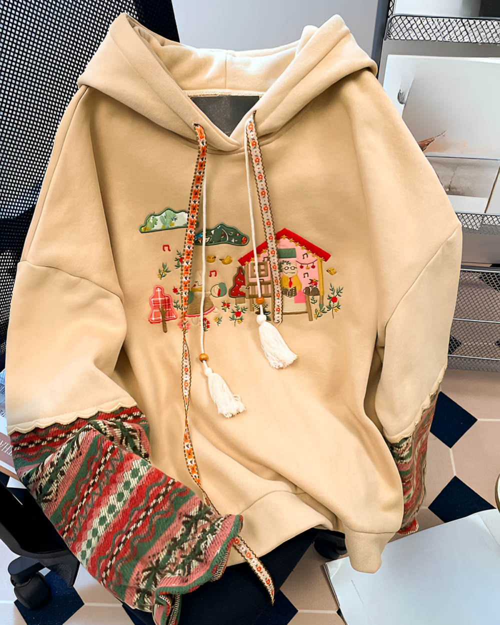 House on the Mountains hoodie featuring an embroidered mountain scene and floral details.