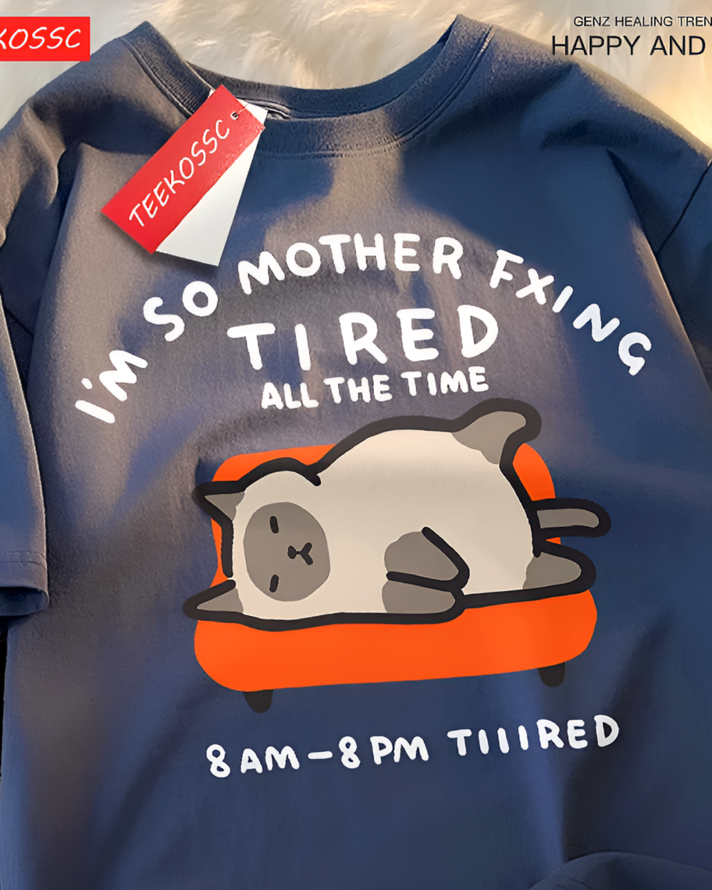 Navy blue T-shirt with a graphic of a tired cat. Features the text "I'm So Mother Fxing Tired All The Time" and "8 AM - 8 PM TIIIRED". A Tired Neko T-Shirt.