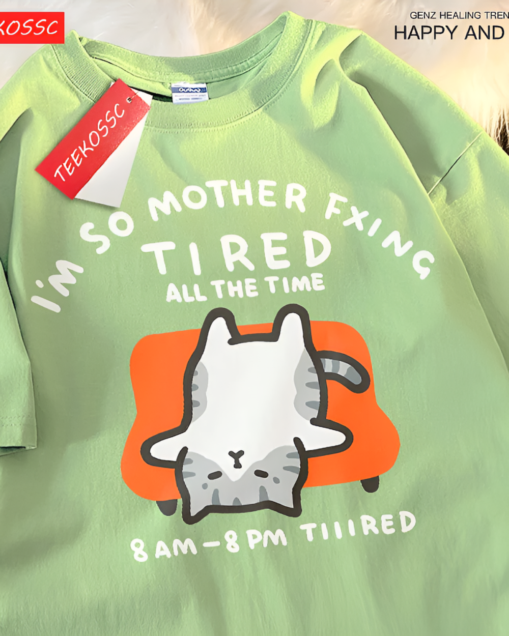 Light green T-shirt with a graphic of a tired cat and text reading "I'm So Mother Fxing Tired All The Time." This is a Tired Neko T-Shirt.