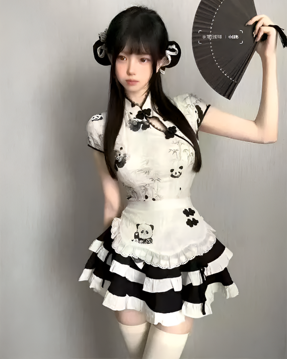 Model wearing a black and white panda maid dress with ruffled skirt. A cute panda maid dress design with panda graphics.