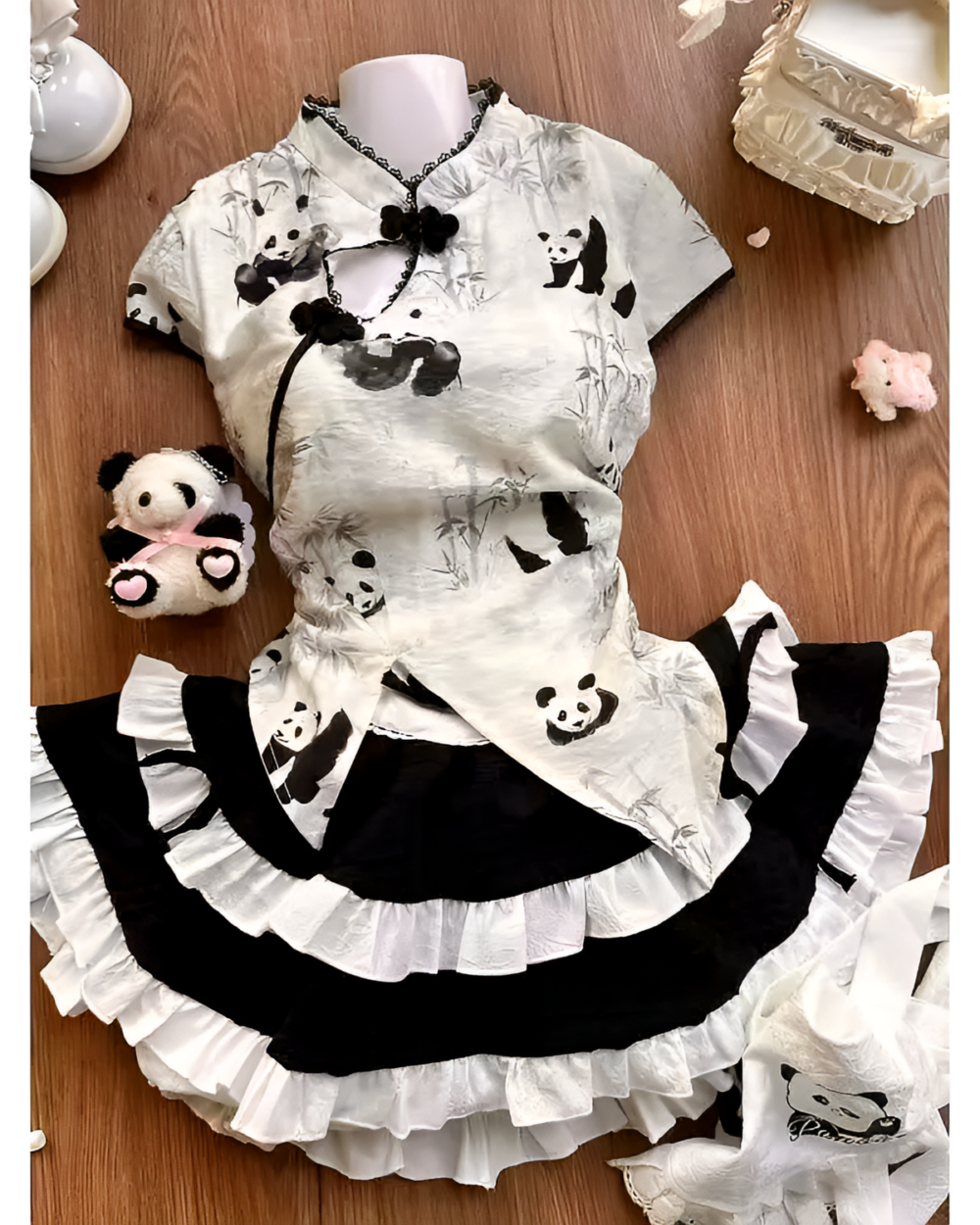 Inkwell Panda Maid Dress laid flat. Features panda graphics and a ruffled hem. Includes a matching panda plushie.