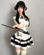 Woman wearing an Inkwell Panda Maid Dress with a black and white panda print and ruffled apron. This is a panda maid dress costume.