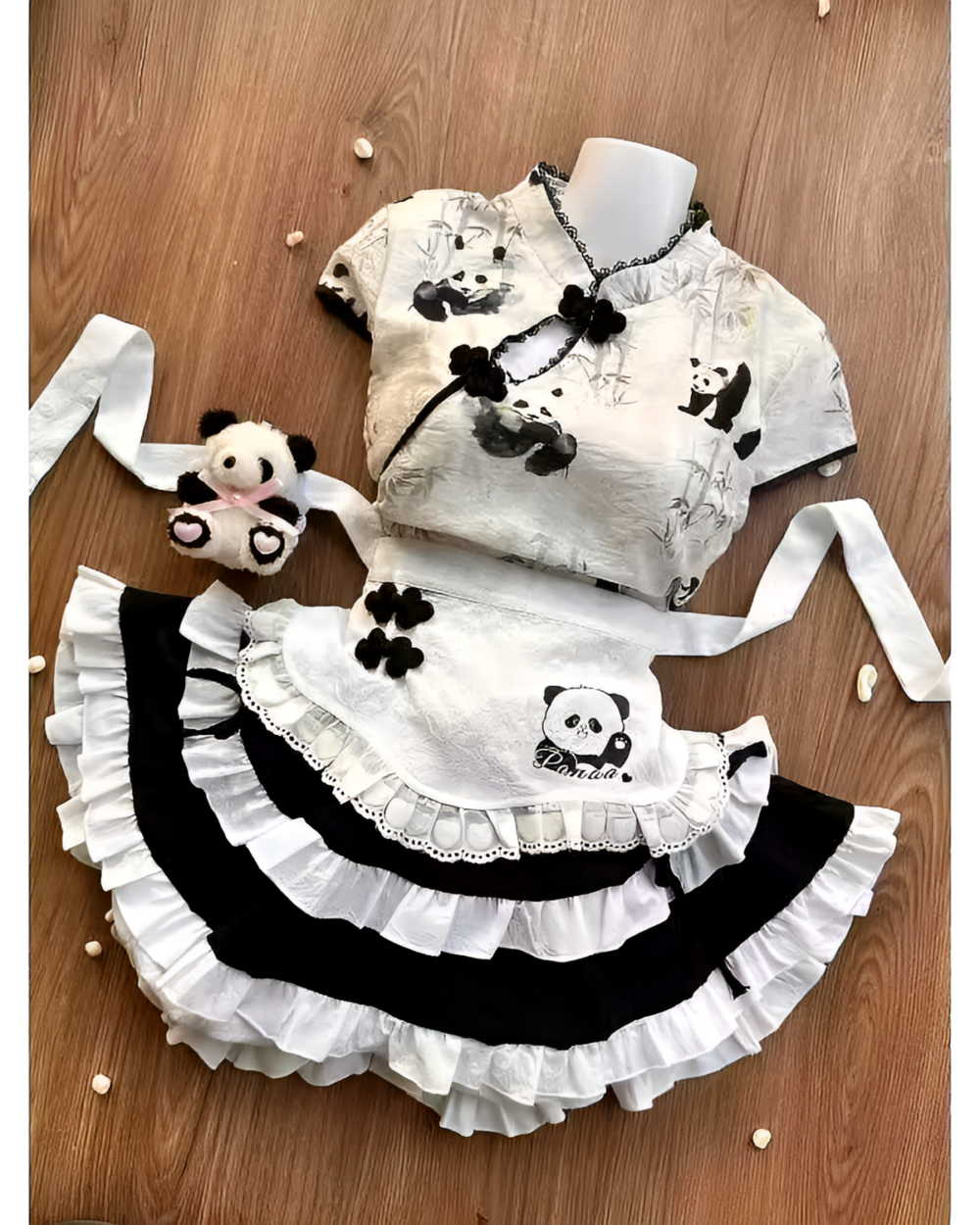Inkwell Panda Maid Dress with a panda plushie. This stylish outfit features a black and white panda design, including a cheongsam-style top and ruffled apron.