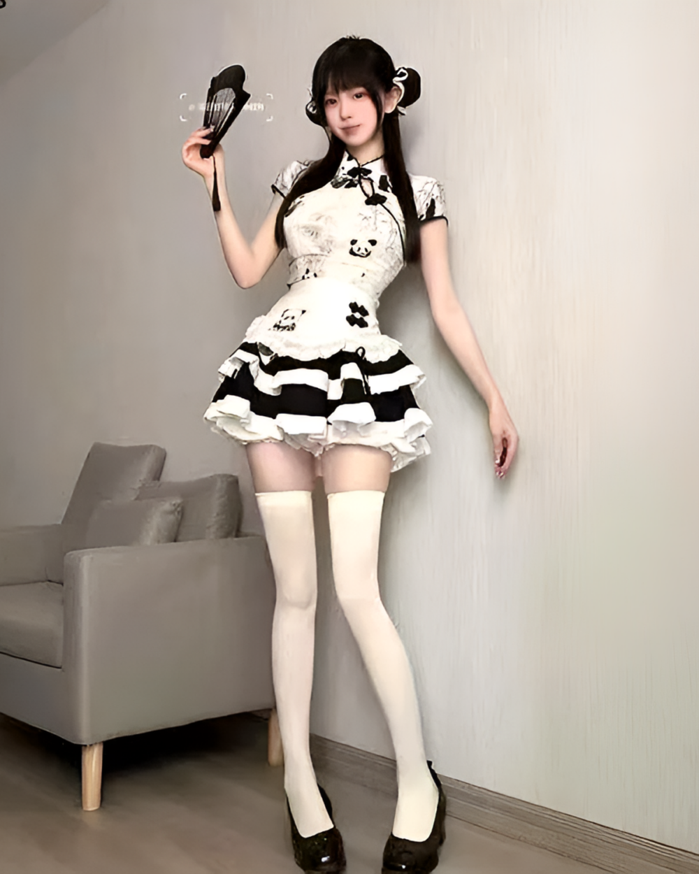 Model wearing an Inkwell Panda Maid Dress with white thigh-high socks and black heels. Cute panda maid dress with a ruffled hem.