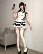 Model wearing an Inkwell Panda Maid Dress with white thigh-high socks and black heels. Cute panda maid dress with a ruffled hem.