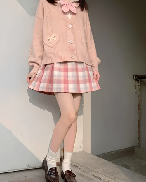 Pink Japanese knitted cardigan with bow detail and pockets.
