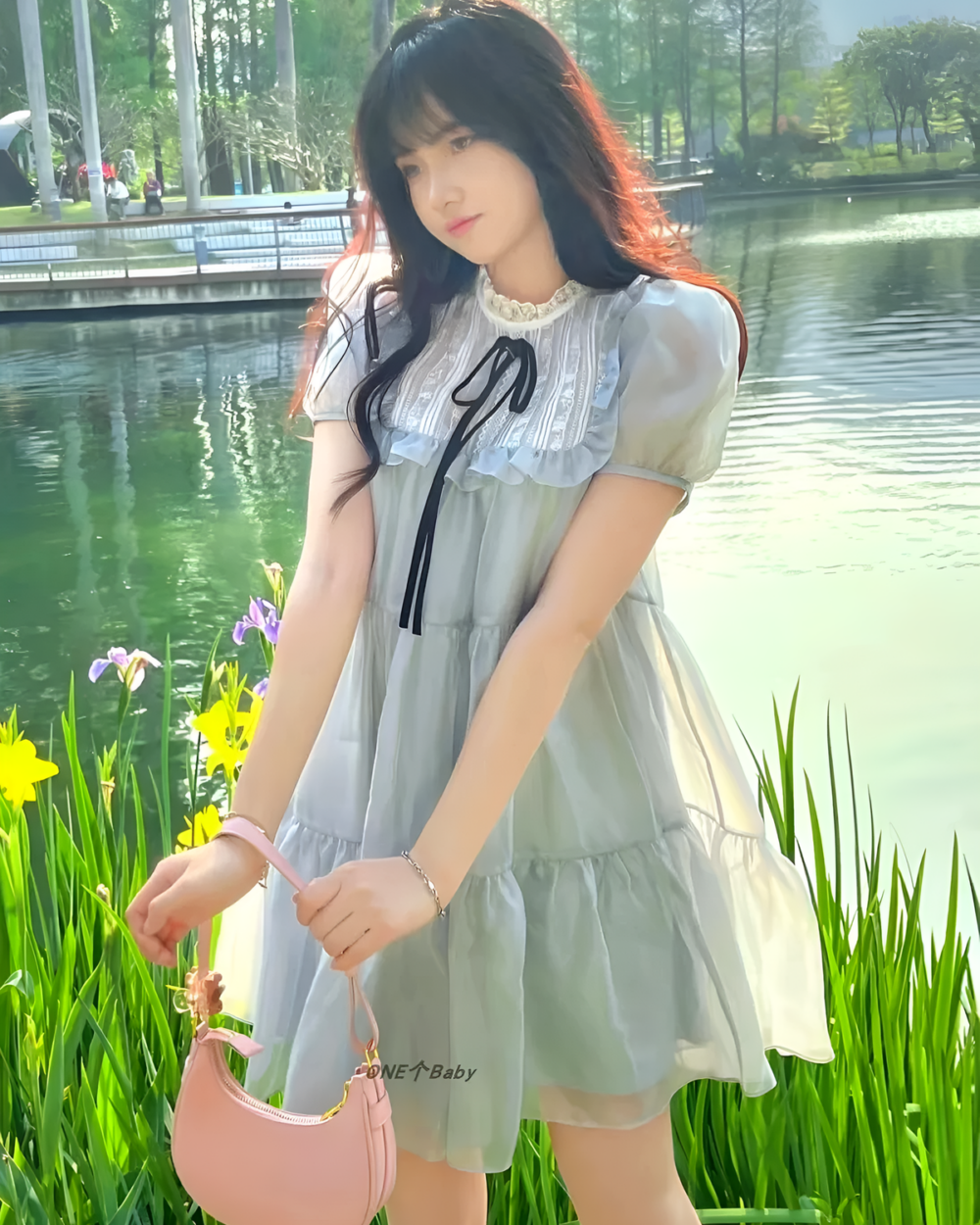 Woman wearing a grey japanese mesh dress by the water.