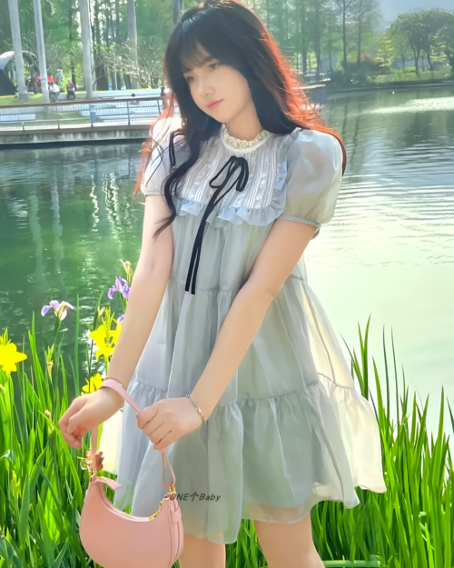 Woman wearing a grey japanese mesh dress by the water.