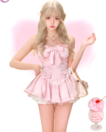 Pink Sweet Lolita dress worn by a model, featuring a bow and lace details.