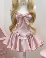 Pink Sweet Lolita dress with lace trim and bows, worn on a mannequin.