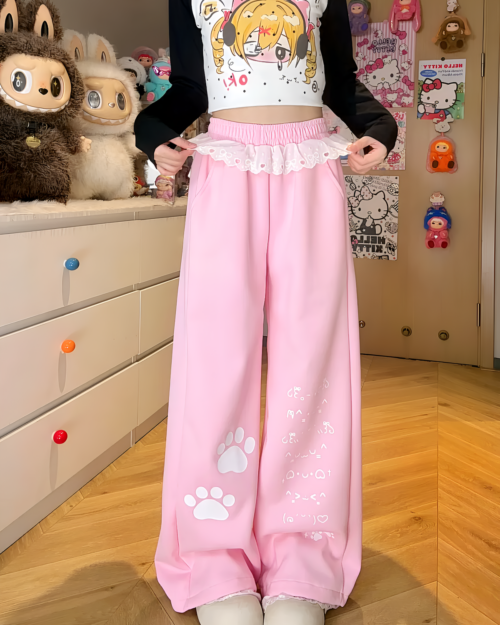 Kaomoji Paw Print Pants featuring paw-print details on pink, flowy bottoms.