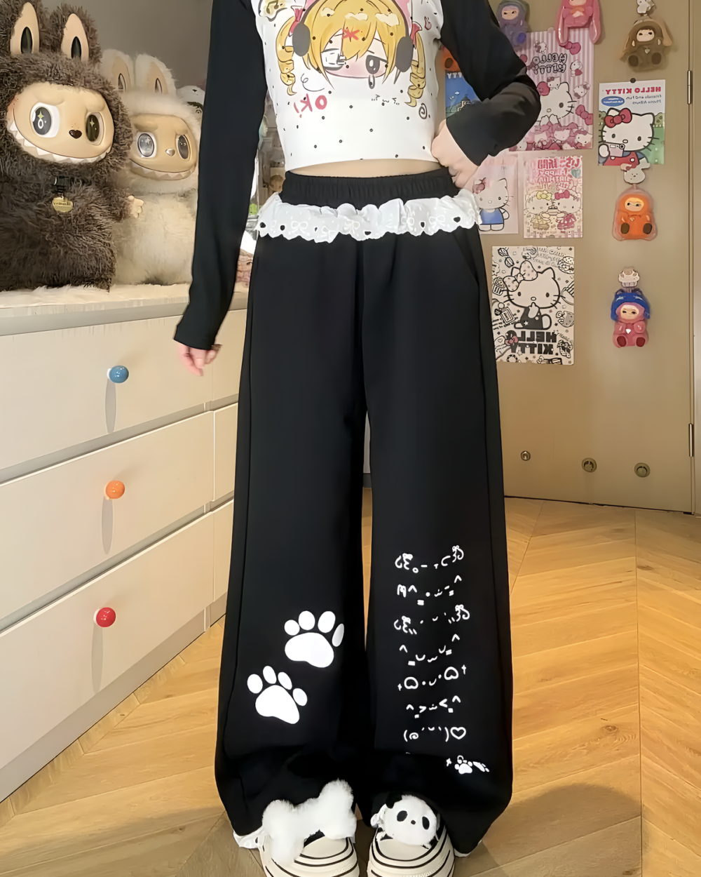 Kaomoji Paw Print Pants featuring adorable paw print details on these black lounge pants.