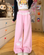 Pink Kaomoji Paw Print Pants, featuring cat paw motifs and a layered design.