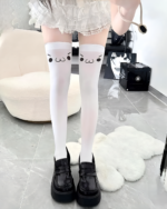 White Kaomoji Suspender Stockings with cartoon face accents, worn with black shoes.