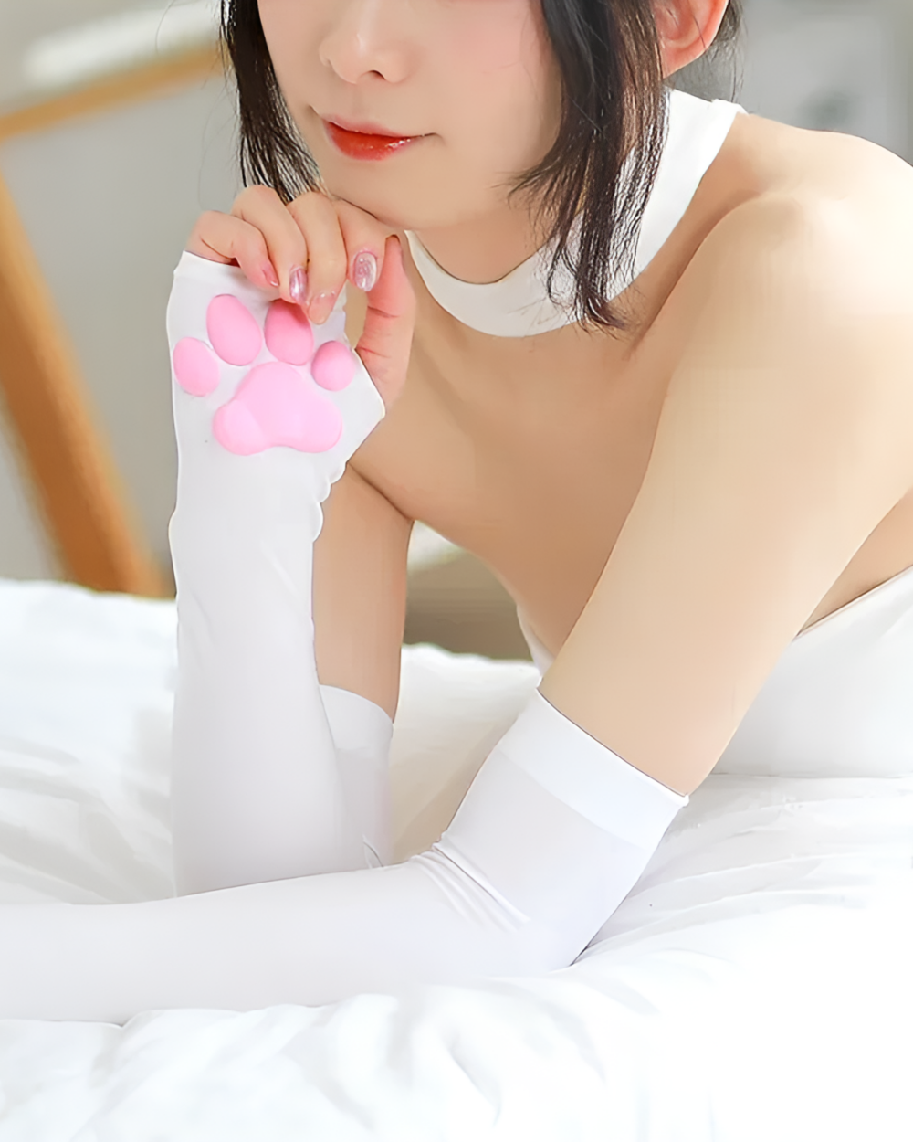 Woman wearing white Kawaii 3D cat paw sleeves with pink paw pads. These 3D cat paw sleeves are a cute accessory.