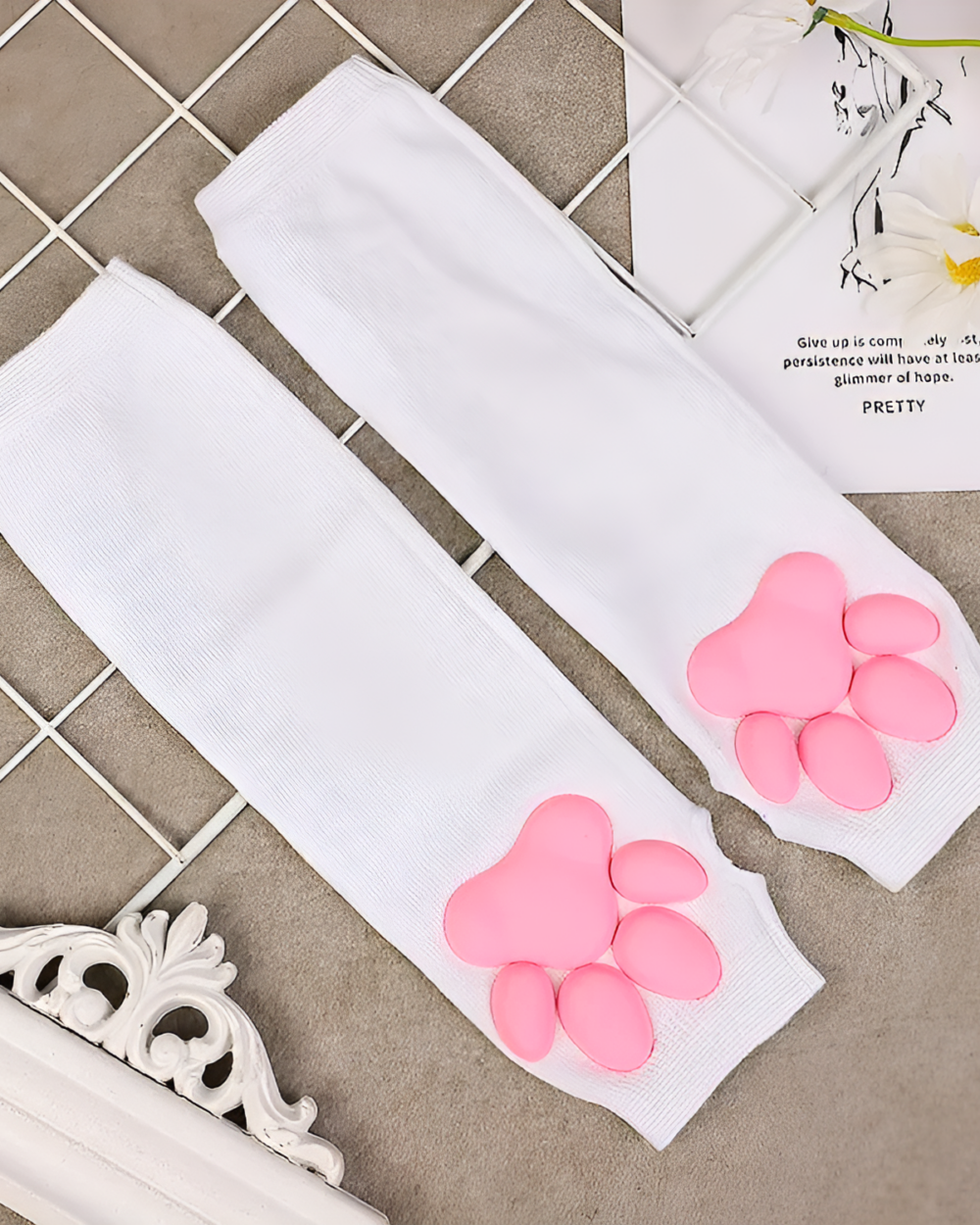White 3D cat paw sleeves with pink paw pads. Kawaii arm warmers for a playful look.