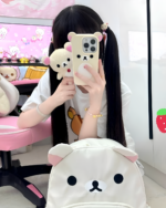 Woman taking a selfie showcasing the white Kawaii Bear Backpack by Jojifuku, featuring a bear face design.