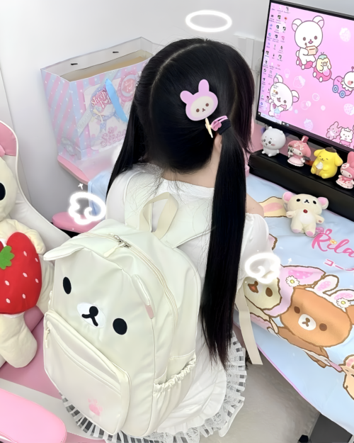 Person wearing a white Kawaii Bear Backpack - Jojifuku. The backpack features a bear face design. Displayed with other plush toys.