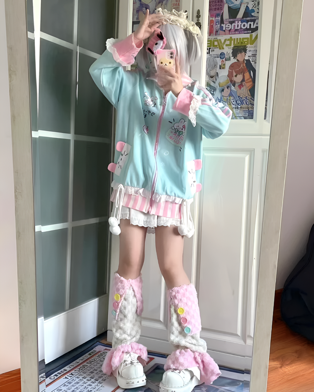 Person wearing a kawaii bunny cardigan jacket with bunny accessories and pink leggings.