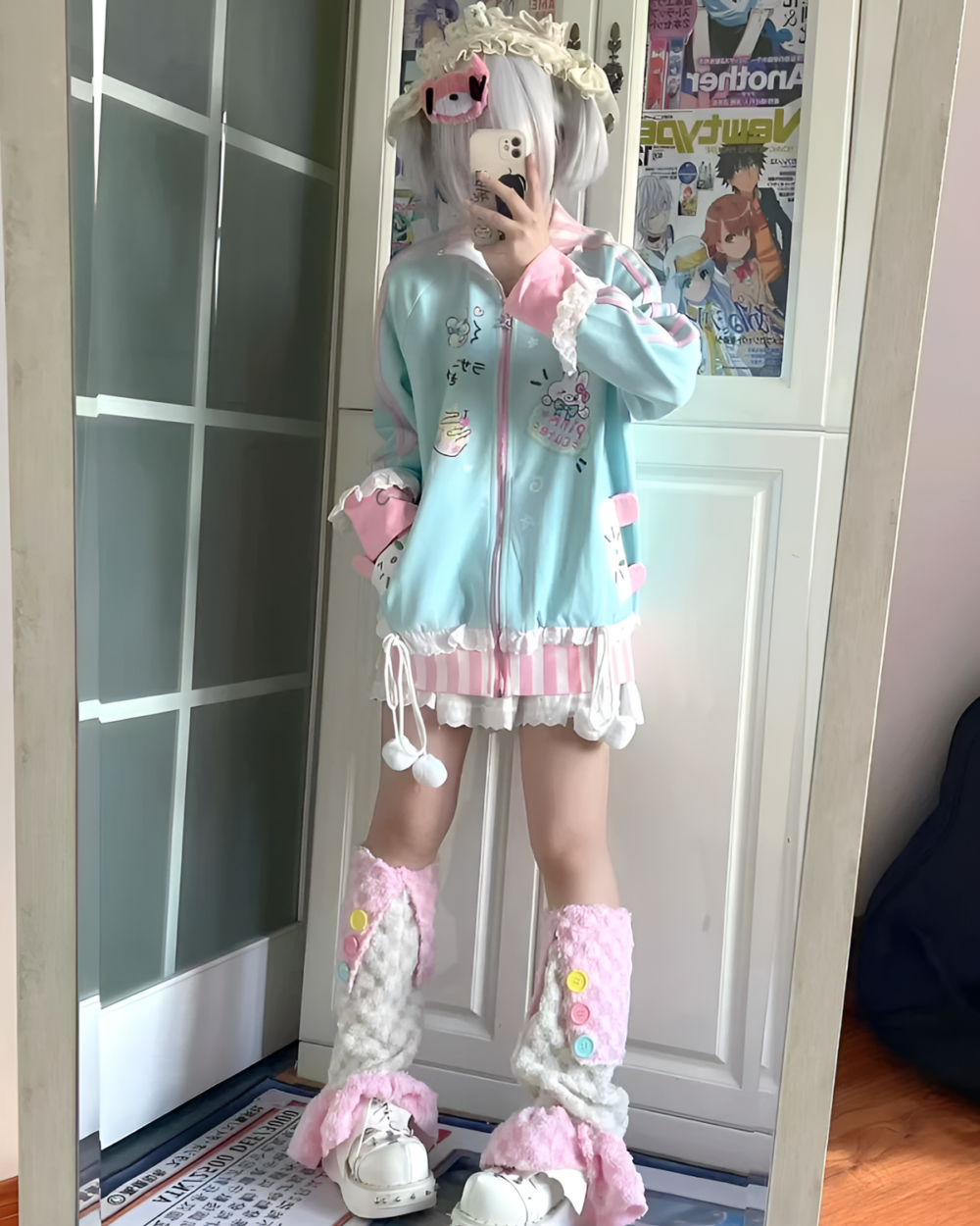 A light blue kawaii bunny cardigan jacket with pink accents, adorned with bunny patches and ruffles.