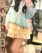 Close-up of a kawaii bunny cardigan jacket with pastel colors and ruffles.