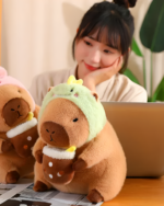 Woman holding a Kawaii Capybara Plushie - Bread & Flower Edition. Cute capybara plushie with a flower cap, displayed with a laptop.