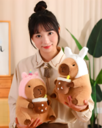 A woman holding Kawaii Capybara Plushies - Bread & Flower Edition. Cute capybara plushie toys in pink and brown colors.