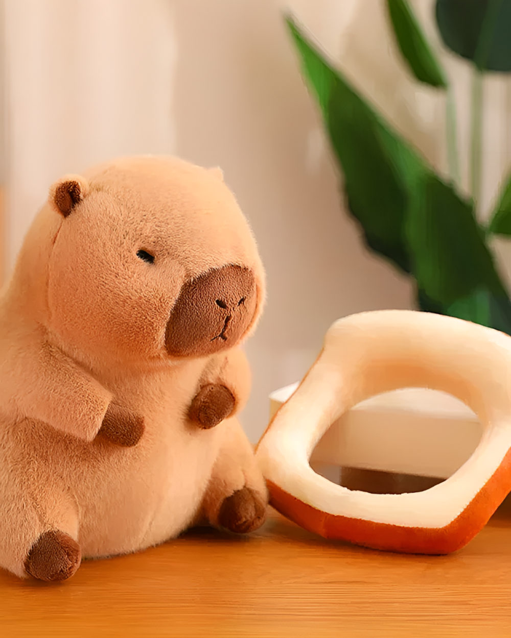 Close-up of a Kawaii Capybara Plushie with a bread slice. Soft, brown capybara plushie toy, part of the Bread & Flower Edition.