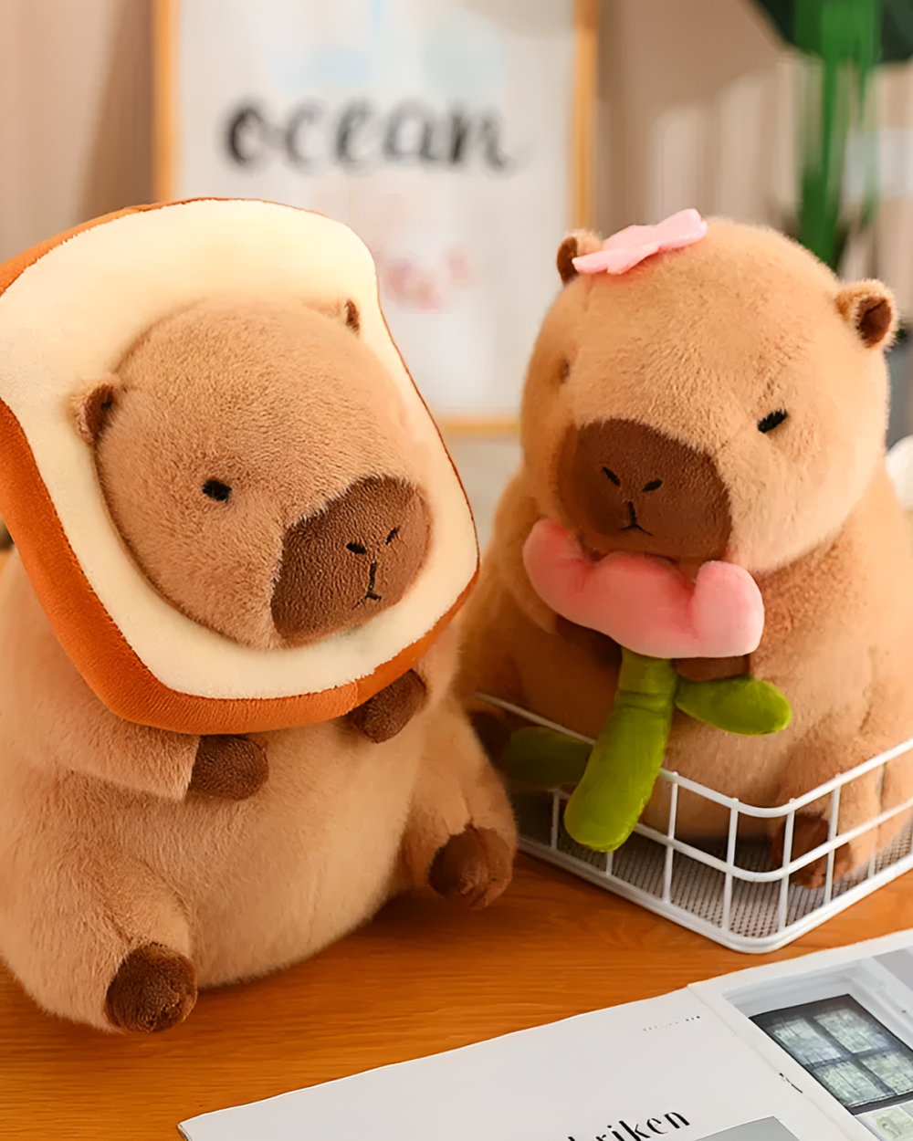 Two Kawaii Capybara Plushies – Bread & Flower Edition are displayed on a wire basket. A cute capybara plushie dressed as bread and one with a flower.