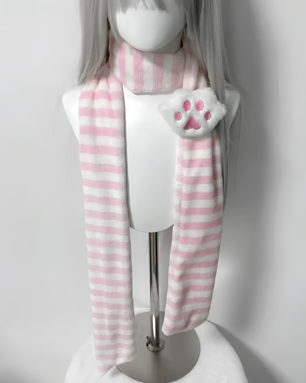 Pink and white striped Kawaii Neko Paw Scarf on a mannequin. Features a fluffy cat paw detail.