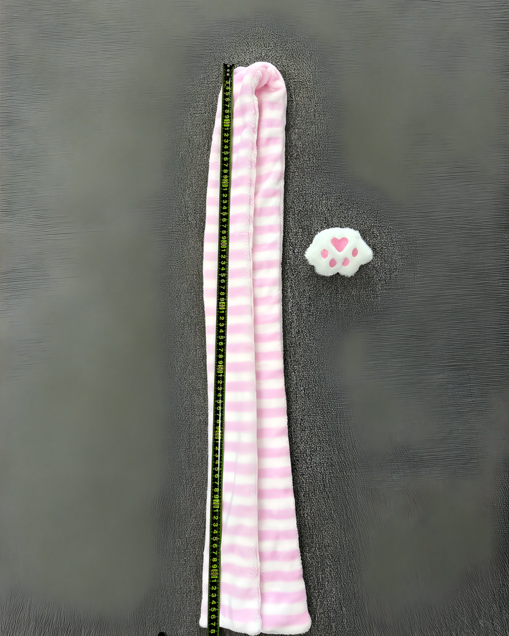 Pink and white Kawaii Neko Paw Scarf with a cat paw print design, laid flat on a grey surface.