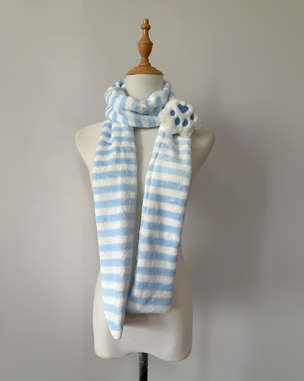 Blue and white striped Kawaii Neko Paw Scarf displayed on a mannequin. Features a fluffy cat paw detail.