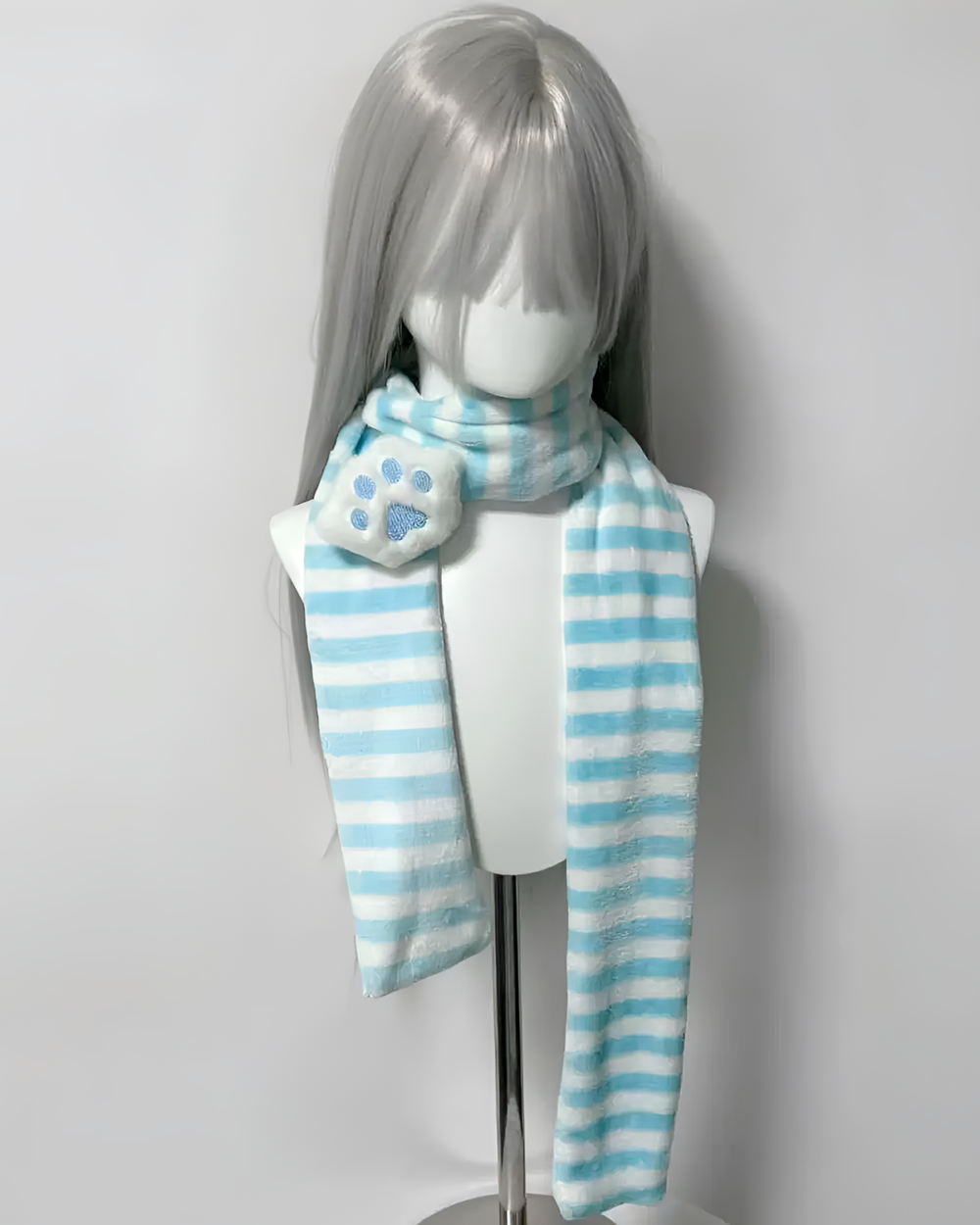 Light blue and white striped Kawaii Neko Paw Scarf on a mannequin head. Features a fluffy paw print detail.