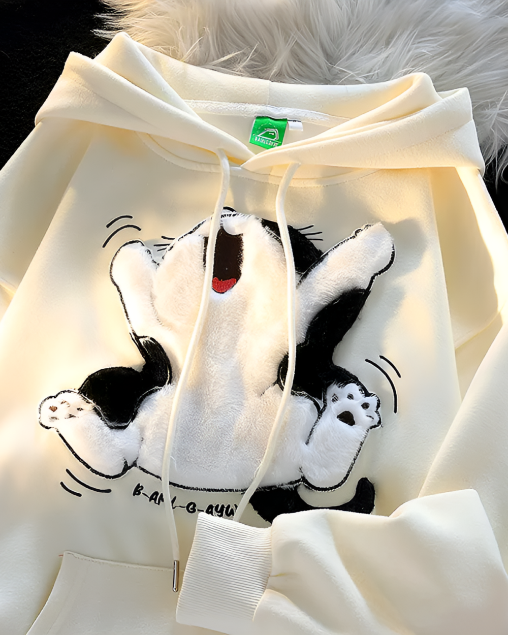 Close-up of a Kawaii Fluffy Neko Pullover Hoodie with a white and black cat design.