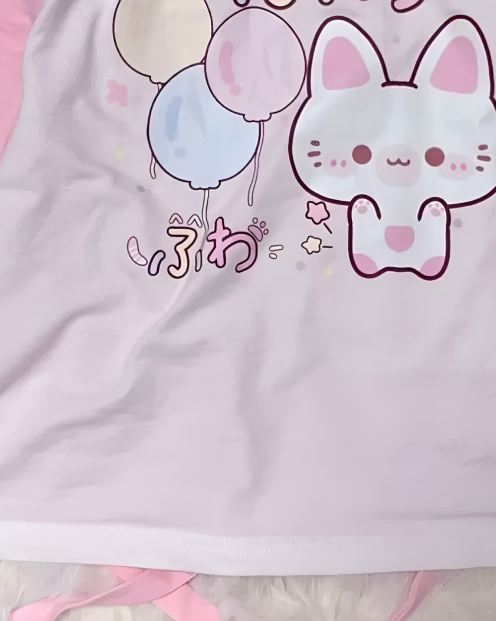 Kawaii Fuwa Fuwa Bunny T-Shirt featuring a pink bunny with balloons and pastel accents on a soft fabric.