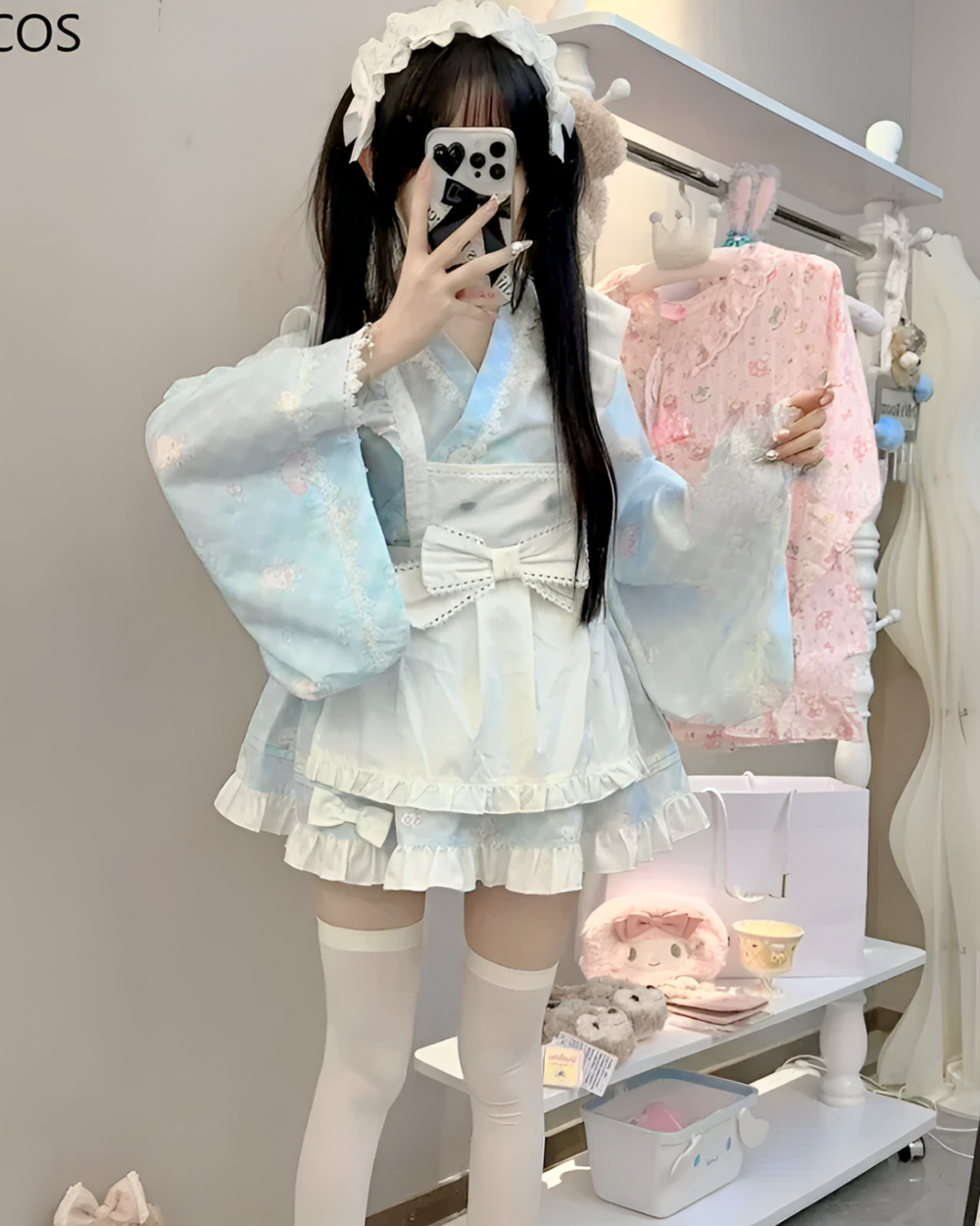 Kawaii lolita style dress featuring ruffled details and a blue floral print, displayed on a mannequin.