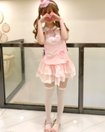 Model wearing a Kawaii Neko Pink Tee, a pink dress with a layered skirt and kawaii cat graphic.