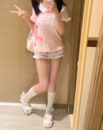 Model wearing a pink Kawaii Neko Tee with cat and bow design.