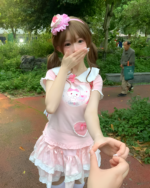 Person wearing a Kawaii Neko Pink Tee, a light pink dress with cat details.