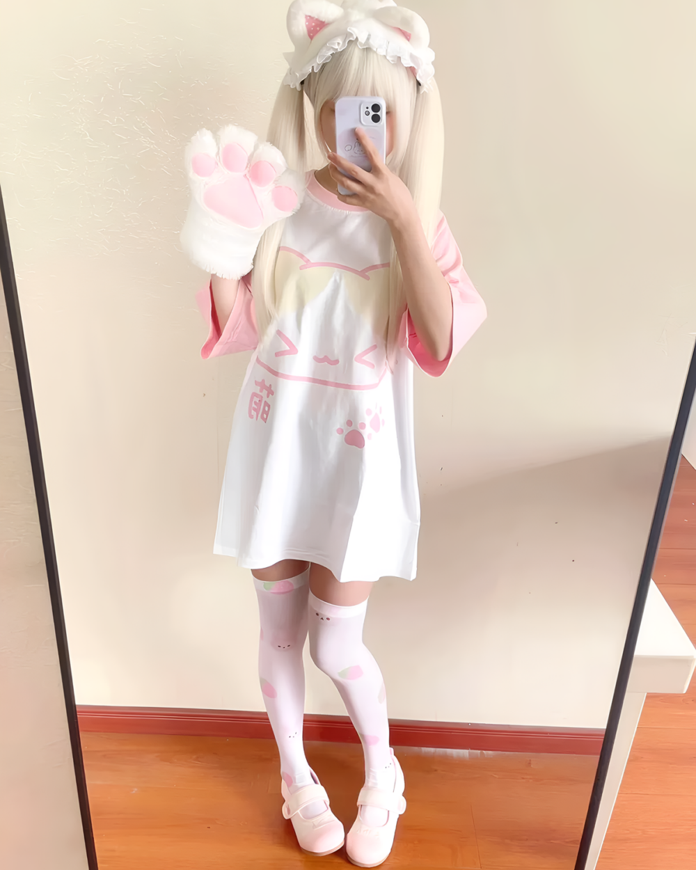 Person wearing a Kawaii Neko T-Shirt with cat paw details and pink accents.